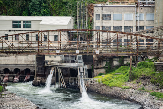 Abandoned papermill factory with rusted bridge