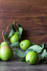 Fresh organic pears and basket on rustic wooden table. Fruit background. Pear autumn harvest.