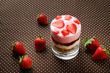 Home made granola breakfast with strawberries and plain yogurt, served in the glass.