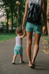 Obraz premium Mother with little daughter walking in the park