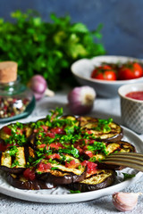 Spicy eggplant with tomato sauce and cilantro. Grilled eggplant.