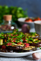 Spicy eggplant with tomato sauce and cilantro. Grilled eggplant.