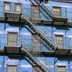 Blue Brick building and outside view with metal stairs in New York City Centre, USA