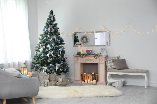 Stylish living room interior with decorated Christmas tree