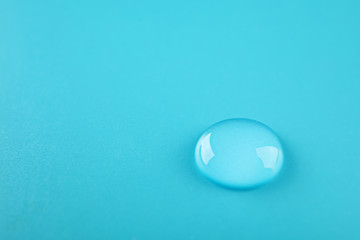 Beautiful clean water drop on color background