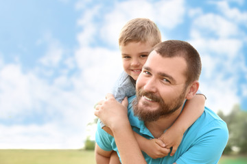 Fototapeta premium Man with his child outdoors. Happy family