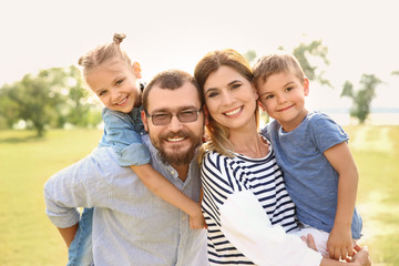 Fototapeta premium Happy family spending time together with their children outdoors