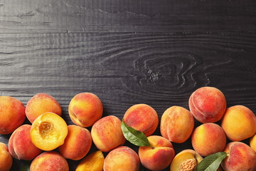 Flat lay composition with ripe peaches on wooden background