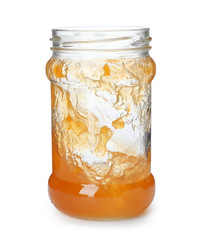 Jar with peach jam on white background