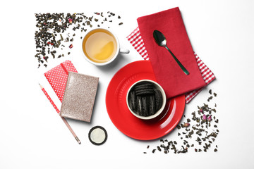 Naklejka premium Flat lay composition with hot tea and cookies on white background