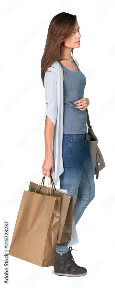 Wall mural young woman with shopping bags isolated on white background