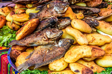 Fried fish & potatoes on streetside food stall in Guatemala
