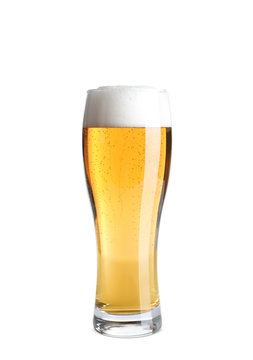 Glass of cold tasty beer on white background
