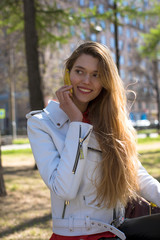 Beautiful young blonde woman calling by phone