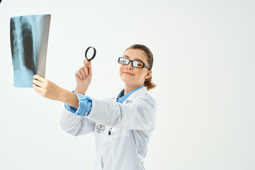 doctor looks at x-ray with magnifying glass