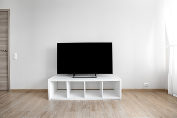 Lcd tv on white shef at modern room interior