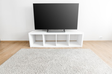 Lcd tv on white shef at modern room interior