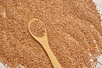 buckwheat in spoon on wooden background