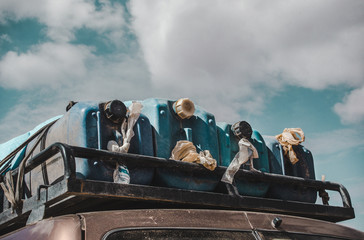 Jerrycans of water supplies on the roof rack of a 4x4 car in preparation for a long road trip in the desert © Lozzy