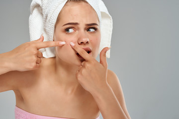 woman applying moisturizer cream on her face