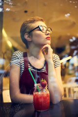 woman in glasses in a cafe