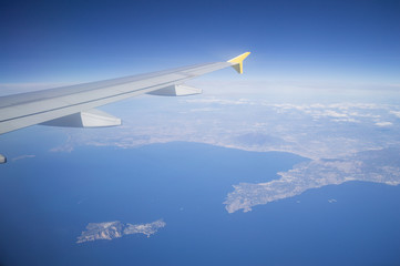 Fototapeta na wymiar Aerial View of Italian Coastline with Wing of Plane in Flight