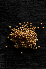 Heap of raw, unprocessed mustard seed kernels on black table