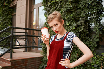 woman with coffee on the city summer street