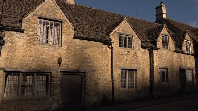 Stone cottage waking up as night shadows disappear through timelapse.