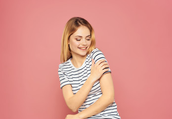 woman in a striped t-shirt on a pink background