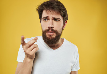 man with a beard on a yellow background portrait