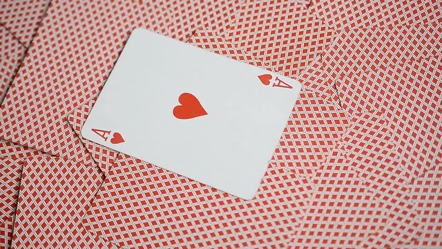 playing cards red background and ace of hearts