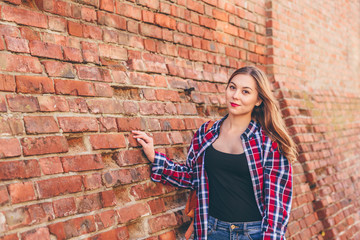 Portrait of young woman in shirt and jeans