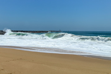 waves crashing on a sandy beach 
