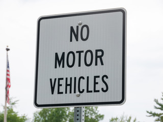 No motor vehicle sign in park with a USA flag on background