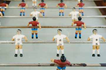 dolls of a retro foosball table to play table football