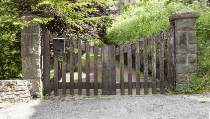Wooden gate in a stone wall on a farm