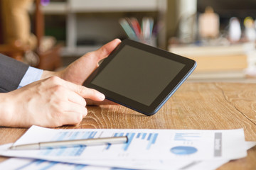 business man using tablet computer on office desk