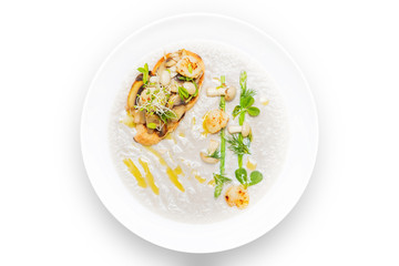 Cream mushroom soup with scallops, herbs and toast bread.