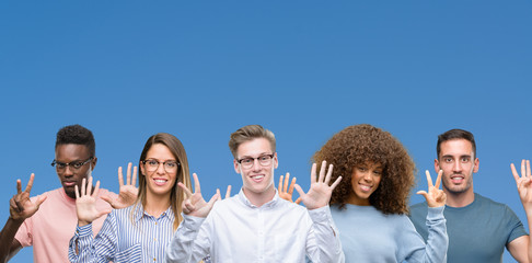 Composition of group of friends over blue blackground showing and pointing up with fingers number eight while smiling confident and happy.