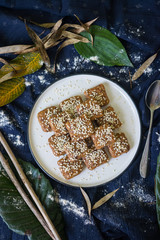 Homemade halva - sweet confections dessert made with tahini (sesame paste) nuts, butter, sunflower seeds, dates, honey, herbs, spices, oil. Vegan sweets. Vegetarian dessert. Arabic Turkish halava