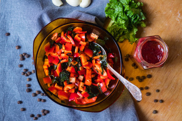 Vegetables salad with red pepper, wakame seaweed, onion, herbs and spices. Vegan lunch, vegetarian dinner, healthy food.