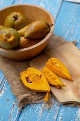 Egg fruit Canistel Yellow Sapote (Pouteria campechiana (Kunth) Baehni) on blue wooden table