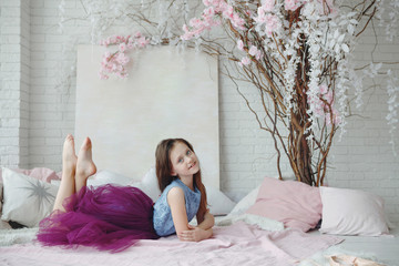 A young girl ballet dancer in a bright pink tutu.