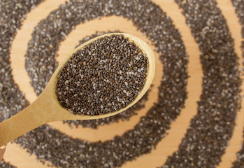Healthy Chia seeds in a wooden spoon on a wooden table