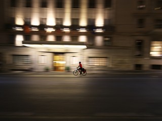 Rome,Italy-July 28, 2018: A man on a bike goes down Cavour street in the night
