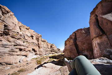 Woman tourist resting in the rocks of San Pedro de Atacama. Chile