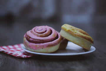 Cakes on a plate, background wooden table
