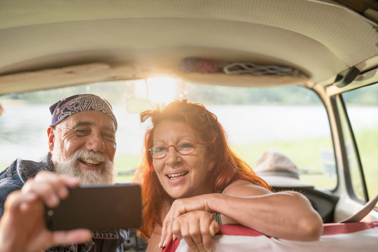  Old Hipster Couple Sitting In A Car Doing A Selfie With A Phone