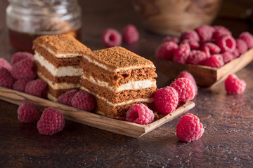Layered honey cake with cream and raspberries.